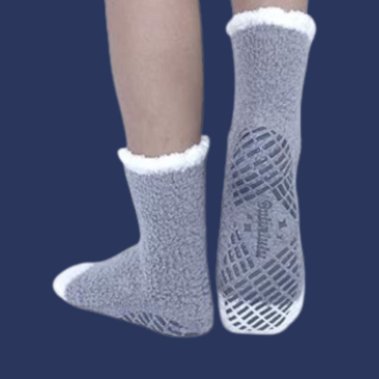 person wearing fuzzy socks, heel-face centrally on a navy background