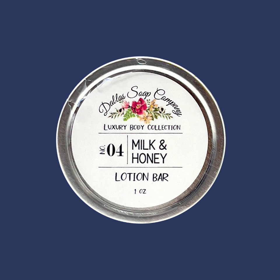 A round lotion bar container with 'Dallas Soap Company Luxury Body Collection' branding and the product number '04 Milk & Honey Lotion Bar' on it. The label features floral and branding elements.