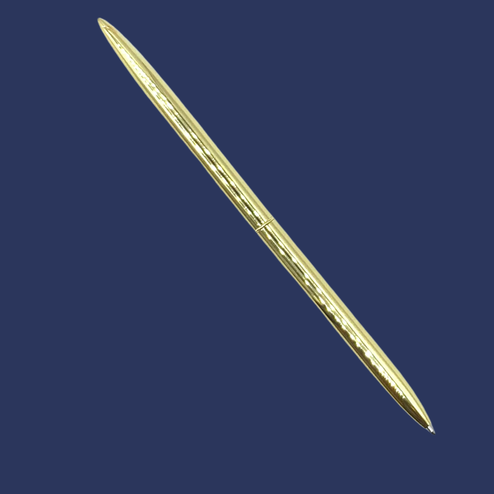 Gold metal ballpoint pen with black ink on a navy background