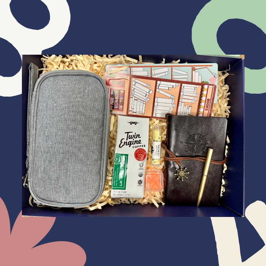 gift box with journal, traveling case, bookmarks, lip balm, earplugs, and twin engine coffee; shown in the box as if someone were opening it