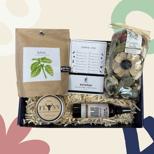 Gifting box with basil tea, notepad, and other items on a colorful abstract background