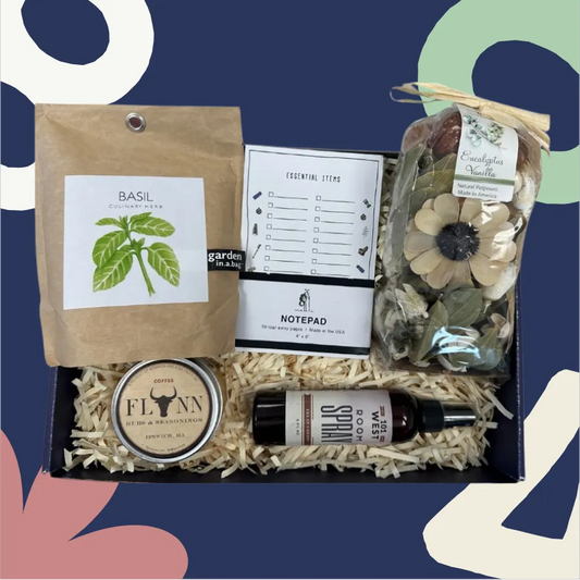 Gift set with basil seeds, notepad, and other items on a blue background