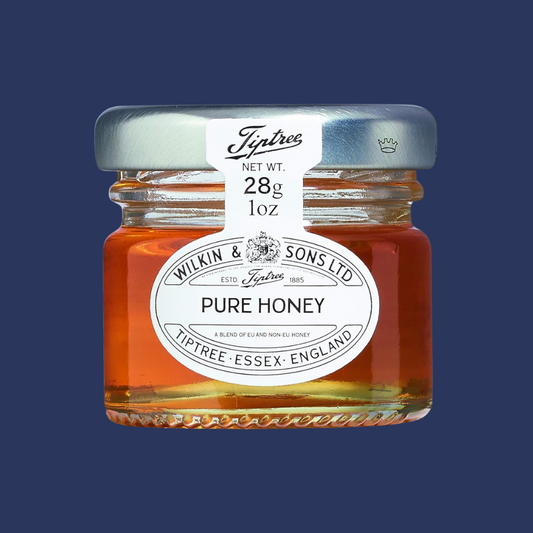 jar of wilkin and sons pure honey placed centrally on a navy background
