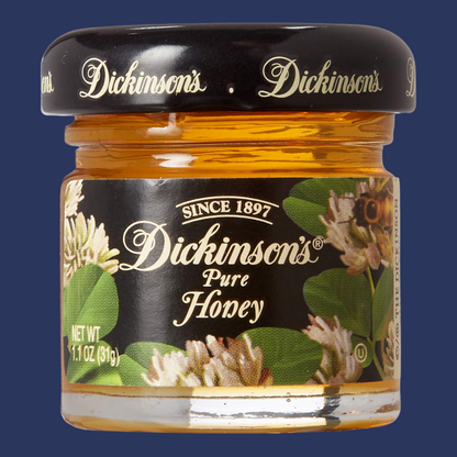 A jar of Dickinson's Pure Honey with a black lid and a label that shows the brand name and the words 'Since 1897'.