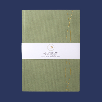 LSW London green notebook with gold debossed cover and white spine, centrally placed on a navy background.
