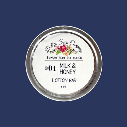 A round lotion bar container with 'Dallas Soap Company Luxury Body Collection' branding and the product number '04 Milk & Honey Lotion Bar' on it. The label features floral and branding elements.