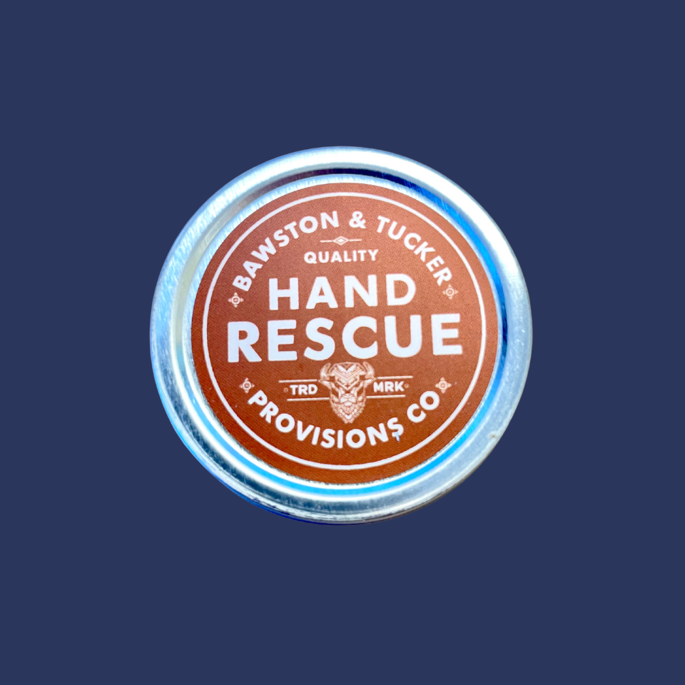 bawston and tucker hand rescue lotion with orange and blue shades on the tin can; placed centrally on a navy background