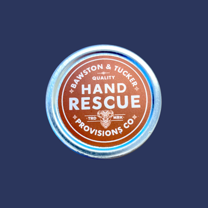 bawston and tucker hand rescue lotion with orange and blue shades on the tin can; placed centrally on a navy background
