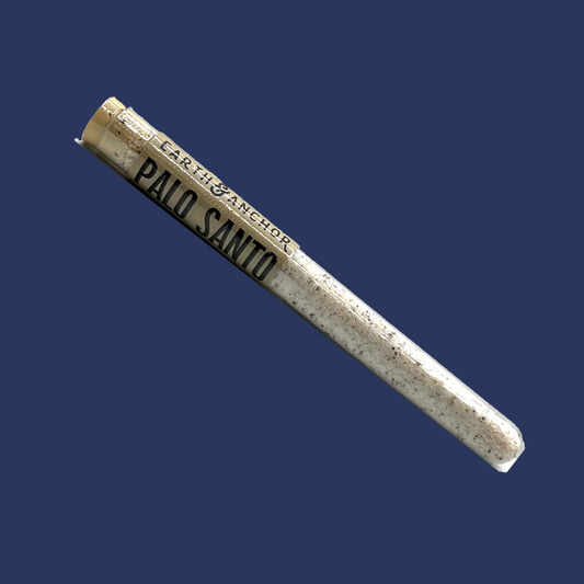 A cylindrical container labeled 'Earth and Anchor Soap Company, Palo Santo' with a navy background.